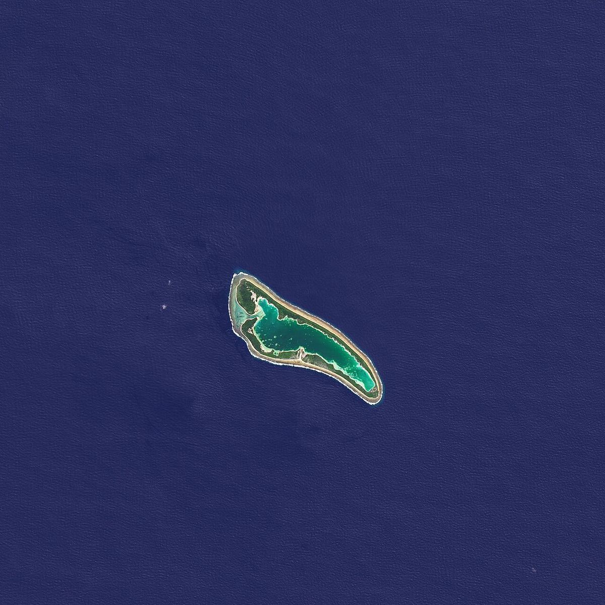 Satellite view of Nikumaroro, a ring-shaped coral atoll around a turquoise lagoon in the Pacific